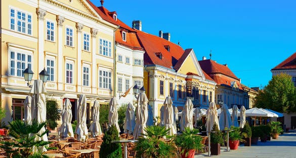 Morning old town view, street terraces of restaurants, green plants and historical architecture, Gyor, Hungary