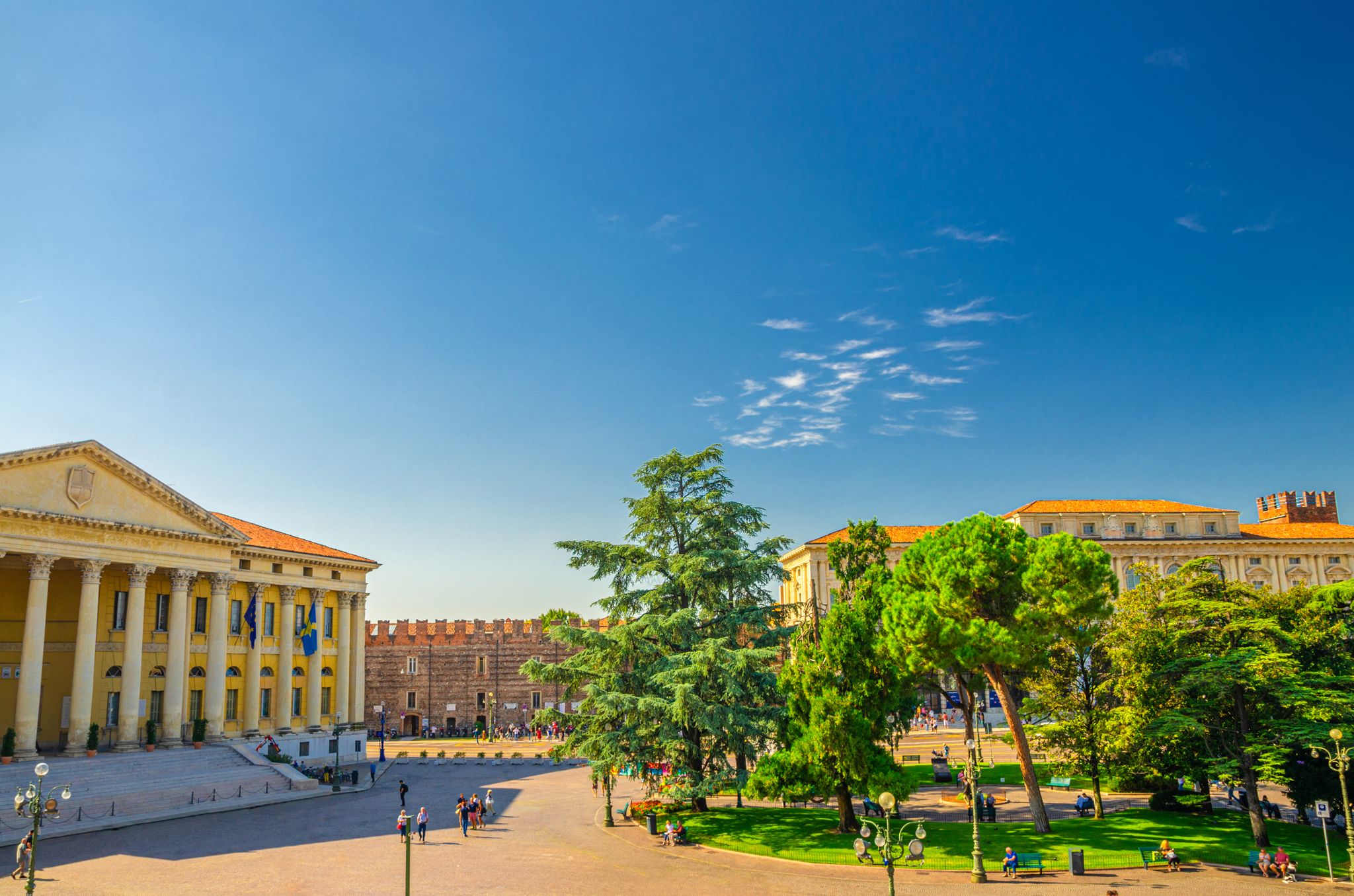 PHOTO OF Piazza Bra square in Verona city historical centre with Palazzo Barbieri town hall building, Palazzo della Gran Guardia and park garden with green cedar and pine trees, Veneto Region, Northern Italy