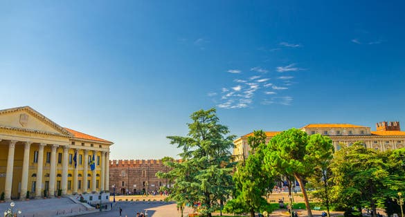 PHOTO OF Piazza Bra square in Verona city historical centre with Palazzo Barbieri town hall building, Palazzo della Gran Guardia and park garden with green cedar and pine trees, Veneto Region, Northern Italy