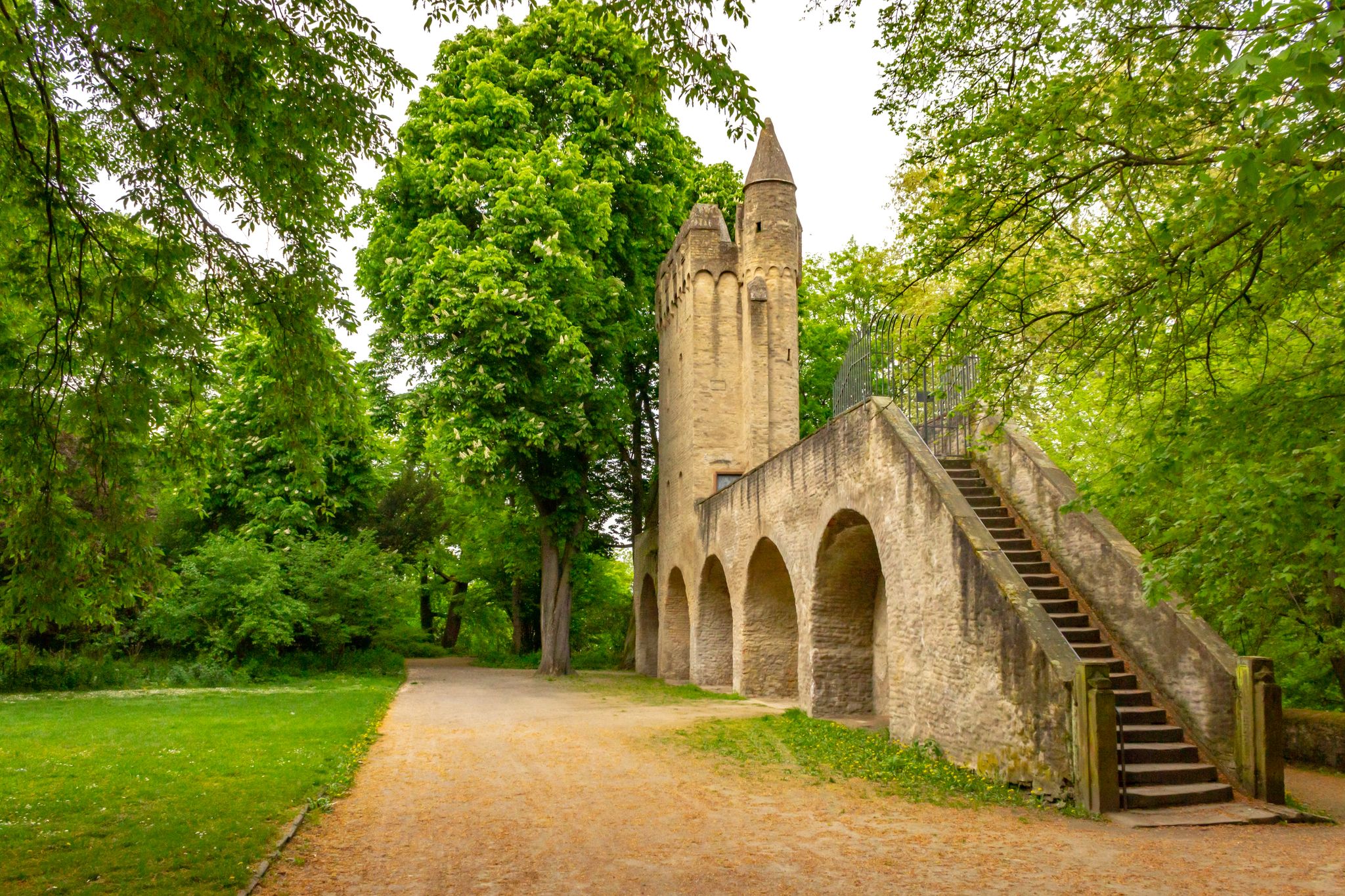 Photo of Park behind Speyer Cathedral with old city fortification and tower, Speyer, Germany.