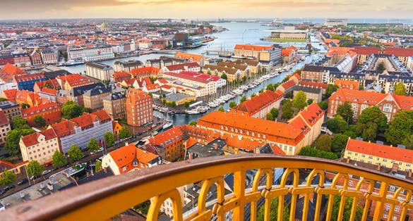 Photo of Skyline of Copenhagen from external winding staircase to the top of church of Vor Frelsers Kirke during sunset, Copenhagen, Denmark.