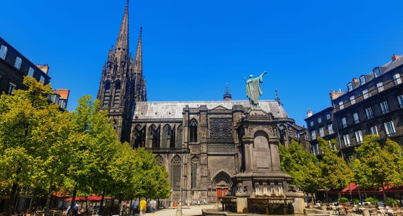 photo of Towering over Clermont-Ferrand city gothic cathedral Notre-Dame-de-l'Assomption building from black lava, France.