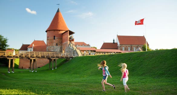 Photo of kids playing near Kaunas castle, Lithuania.