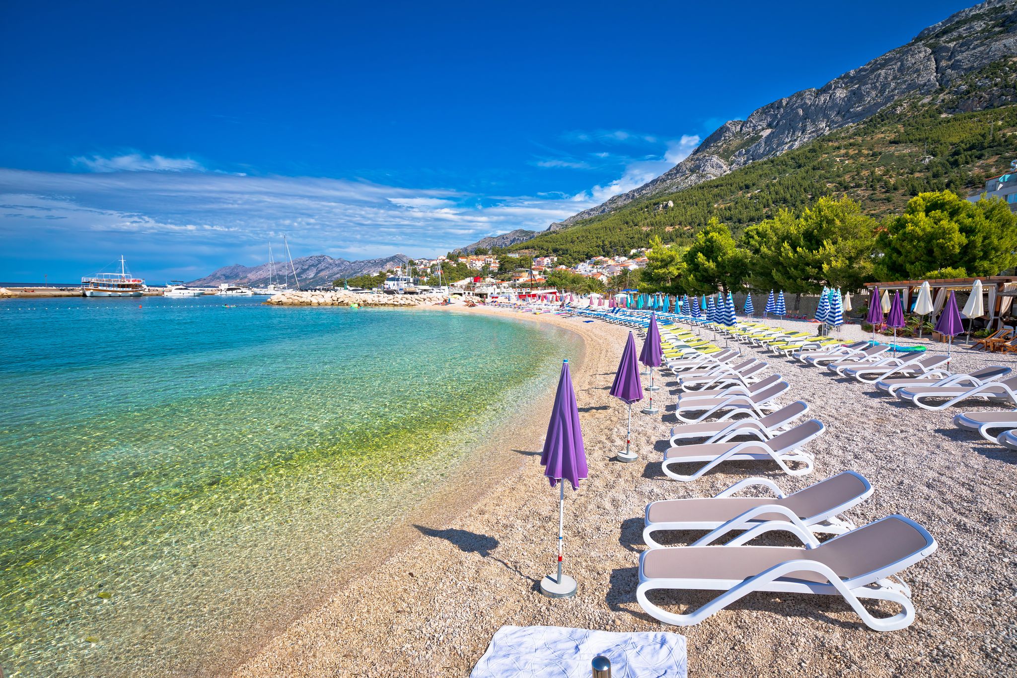 Photo of aerial view on Adriatic Sea and Baska Voda place in Makarska Riviera, Dalmatia region, popular tourist summer resort in Croatia.