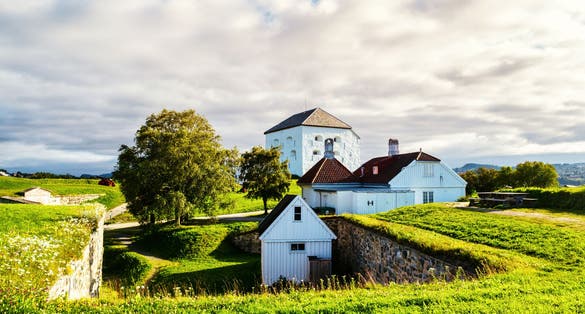 iew of Kristiansten Fortress in Trondheim, Norway during a cloudy summer day.