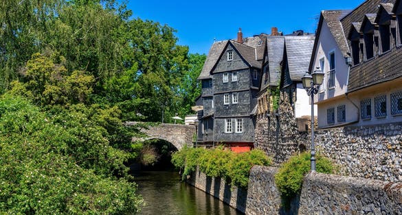 Row of houses of winding, old, partly with slate tiles covered residential houses with a brook in the old town of Wetzlar, Hesse, Germany