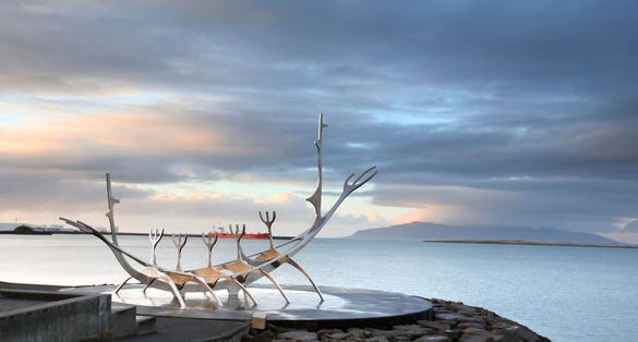photo of sun voyager monument, clouds, landmark of Reykjavik city.