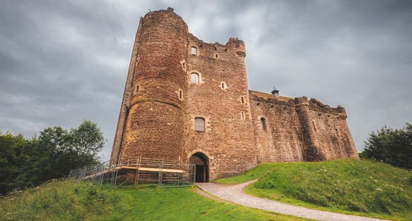 Photo of Historic 14th century medieval Doune Castle, with a dark, moody, dramatic sky in Perthshire, Scotland.