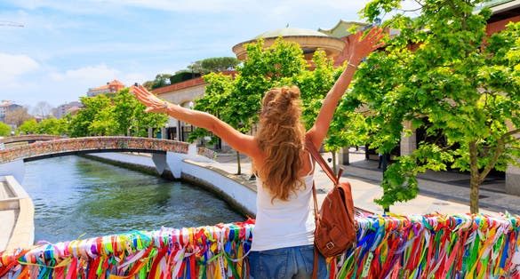 Happy woman tourist visiting famous city Aveiro in Portugal