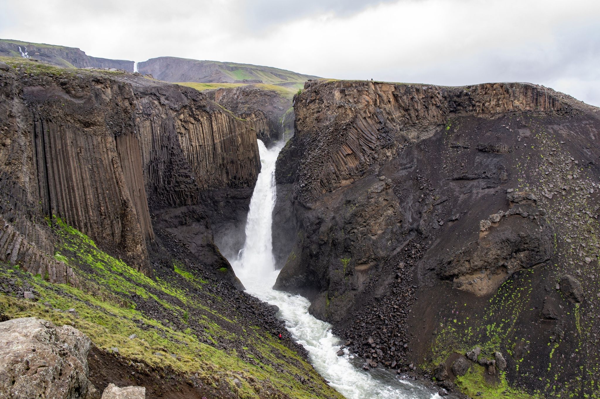 photo of Litlanesfoss waterfall in Iceland with its basaltic geologic landscape in cloudy weather, Iceland