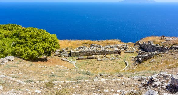 photo of view Ancient Thera housing ruins. Ancient city remains at the Messavouno (Mésa Vounó) mountain on Santorini island, Greece.