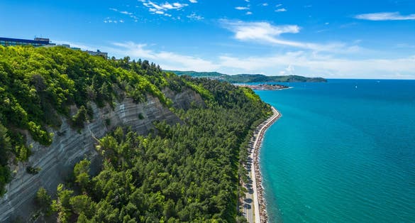 The scenic road between Koper and Izola along the sea coast in Slovenia offers a delightful route for cycling or leisurely walks with breathtaking views of the Adriatic Sea captured by drone