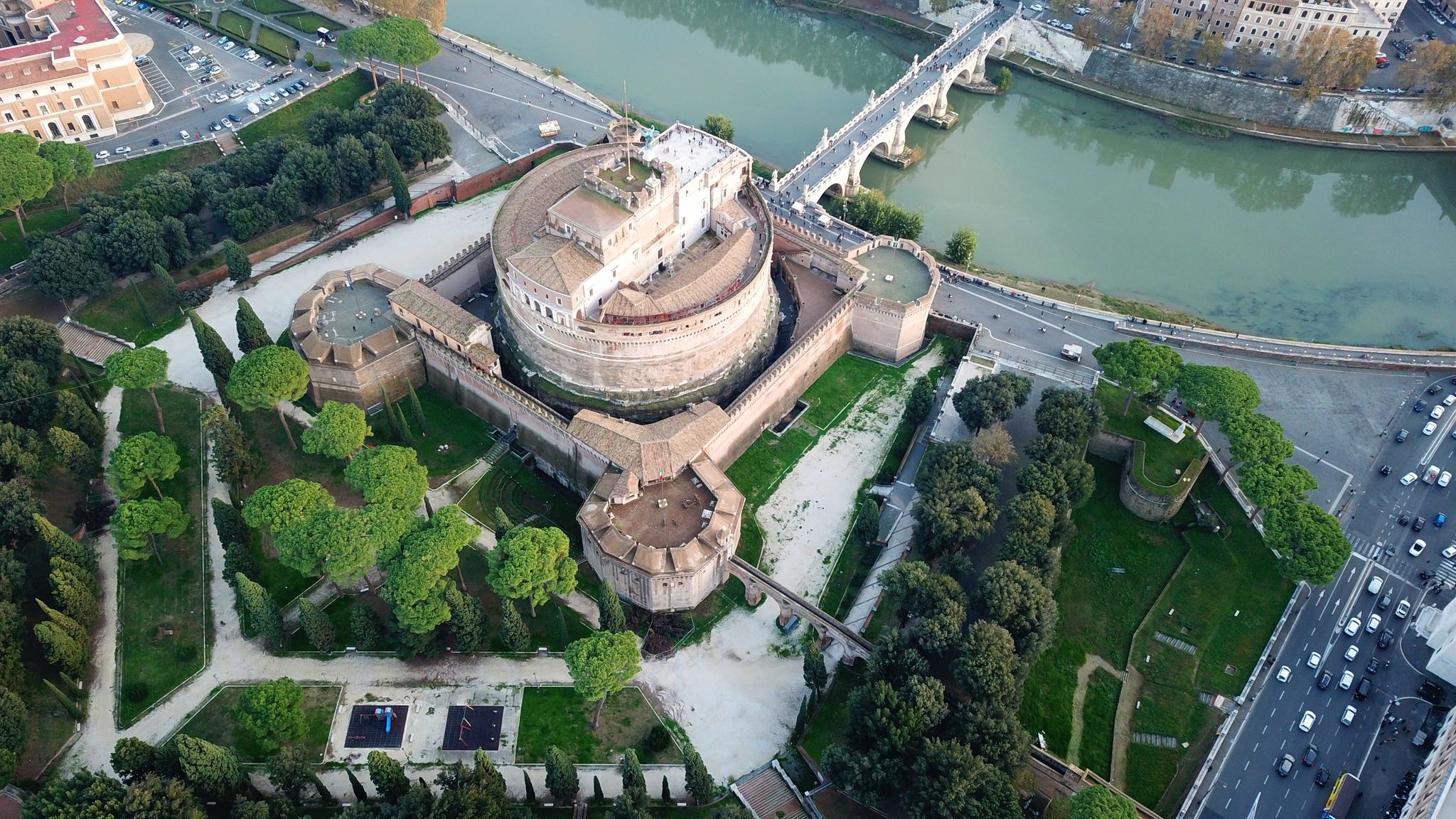 photo of aerial drone view of iconic castel sant'angelo (castle of holy angel) and ponte or bridge sant'angelo with statues in river of tiber next to famous vatican, Rome, Italy.