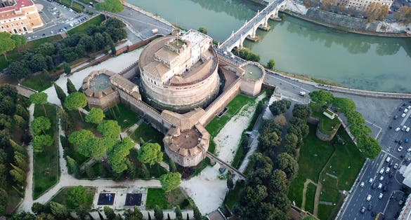 photo of aerial drone view of iconic castel sant'angelo (castle of holy angel) and ponte or bridge sant'angelo with statues in river of tiber next to famous vatican, Rome, Italy.