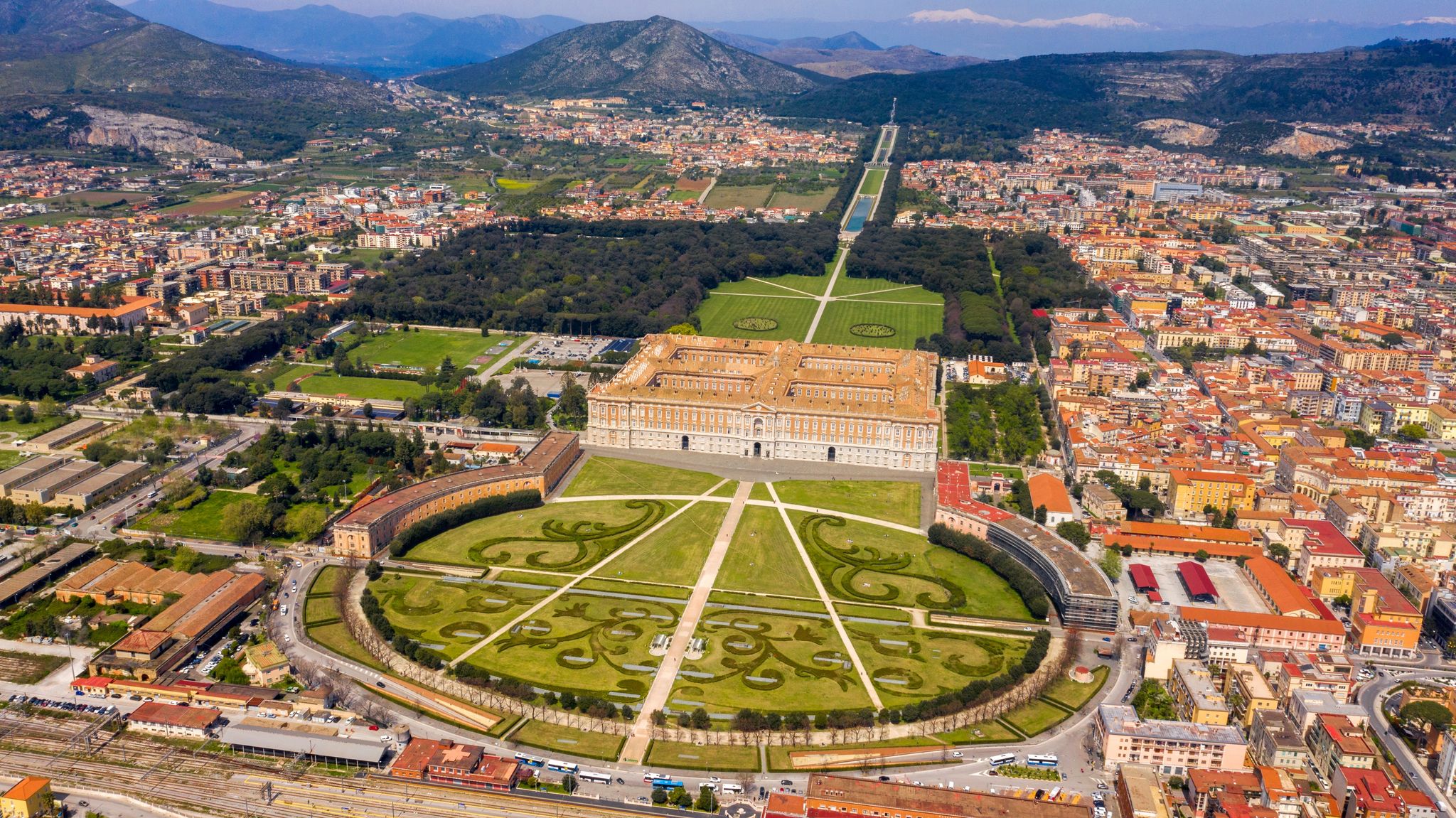 Aerial view of the Royal Palace of Caserta also known as Reggia di Caserta. It is a former royal residence with large gardens in Caserta, near Naples, Italy. The historic center of the city is nearby.