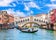 Famous buildings, gondolas and monuments by the Rialto Bridge of Venice on the Grand Canal, Italy.
