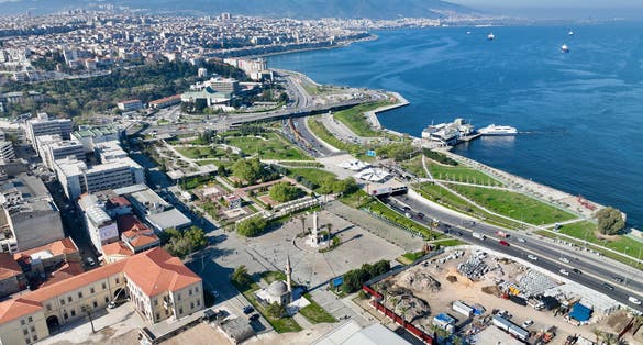 photo of aerial shot of the view of the city of Izmir and the Aegean Sea with Konak Mosque and historical clock tower in Turkey.