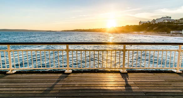 Photo of the view from Bournemouth Pier taken in the evening with the beautiful sunset.