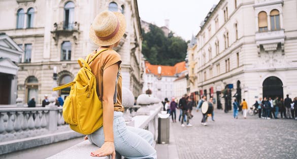 Photo of tourist on Triple Bridge in heart of Ljubljana old town, Slovenia.