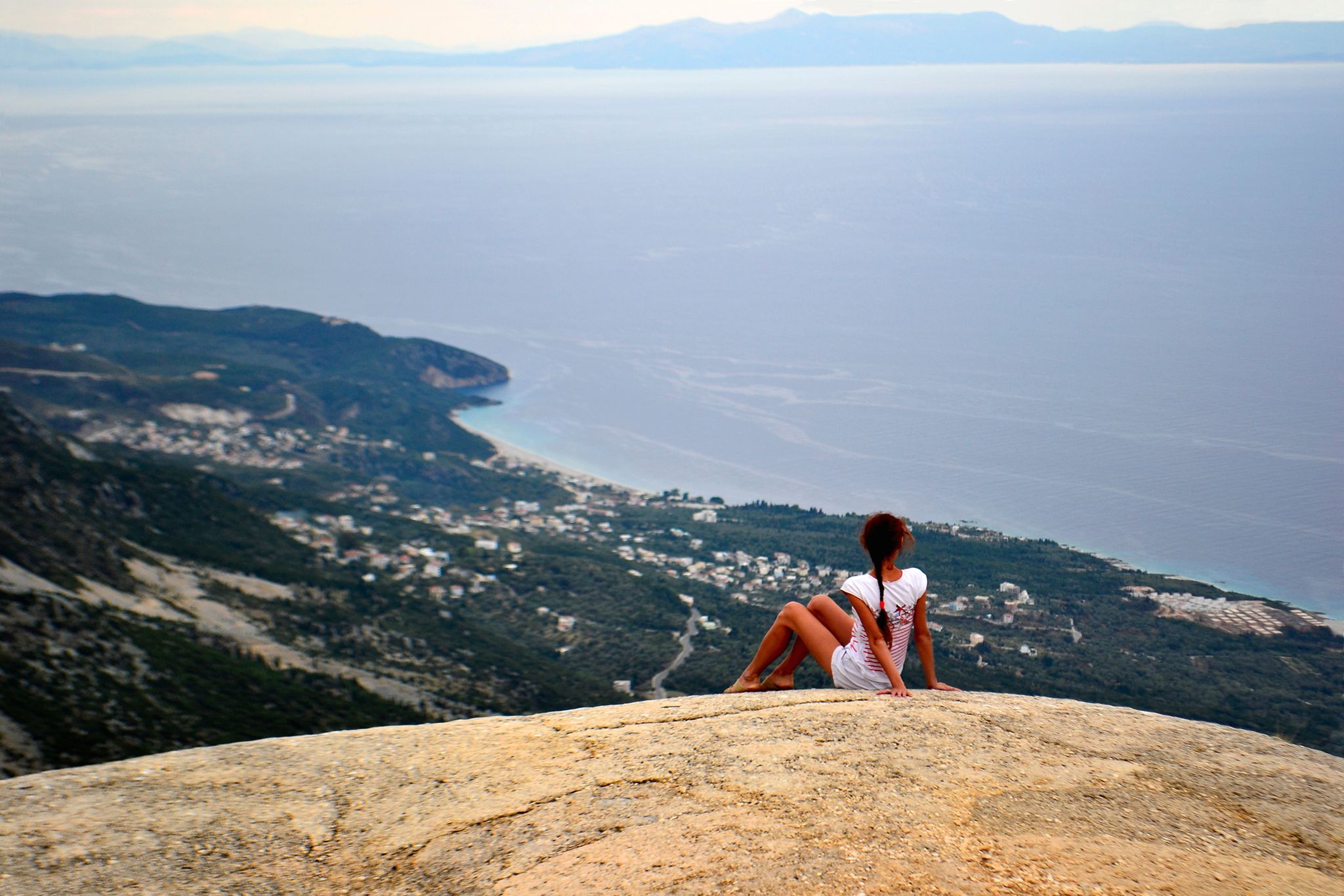 Photo of girl on a big stone. Llogara pass in Llogara National Park, Albania.