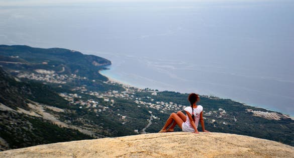 Photo of girl on a big stone. Llogara pass in Llogara National Park, Albania.