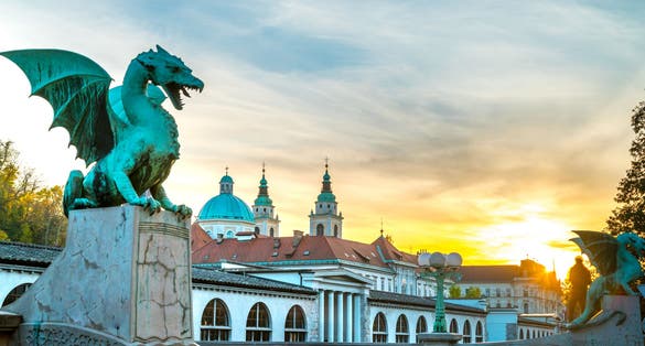 Photo of sunset over famous Dragon bridge (Zmajski most), symbol of Ljubljana, Slovenia.