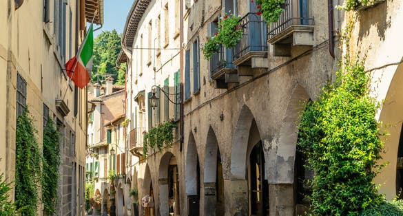 View of the arcades of the ancient village of Asolo in summer, Treviso, Italy