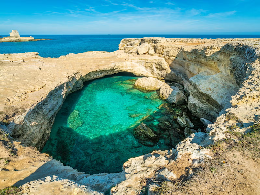 Grotta della Poesia near Lecce, Italy, with crystal-clear turquoise water and rocky cliffs by the sea..png
