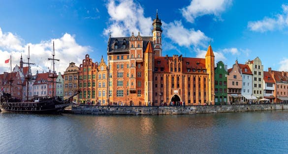 Photo of panorama of the facades of old medieval houses on the promenade in Gdansk, Poland.