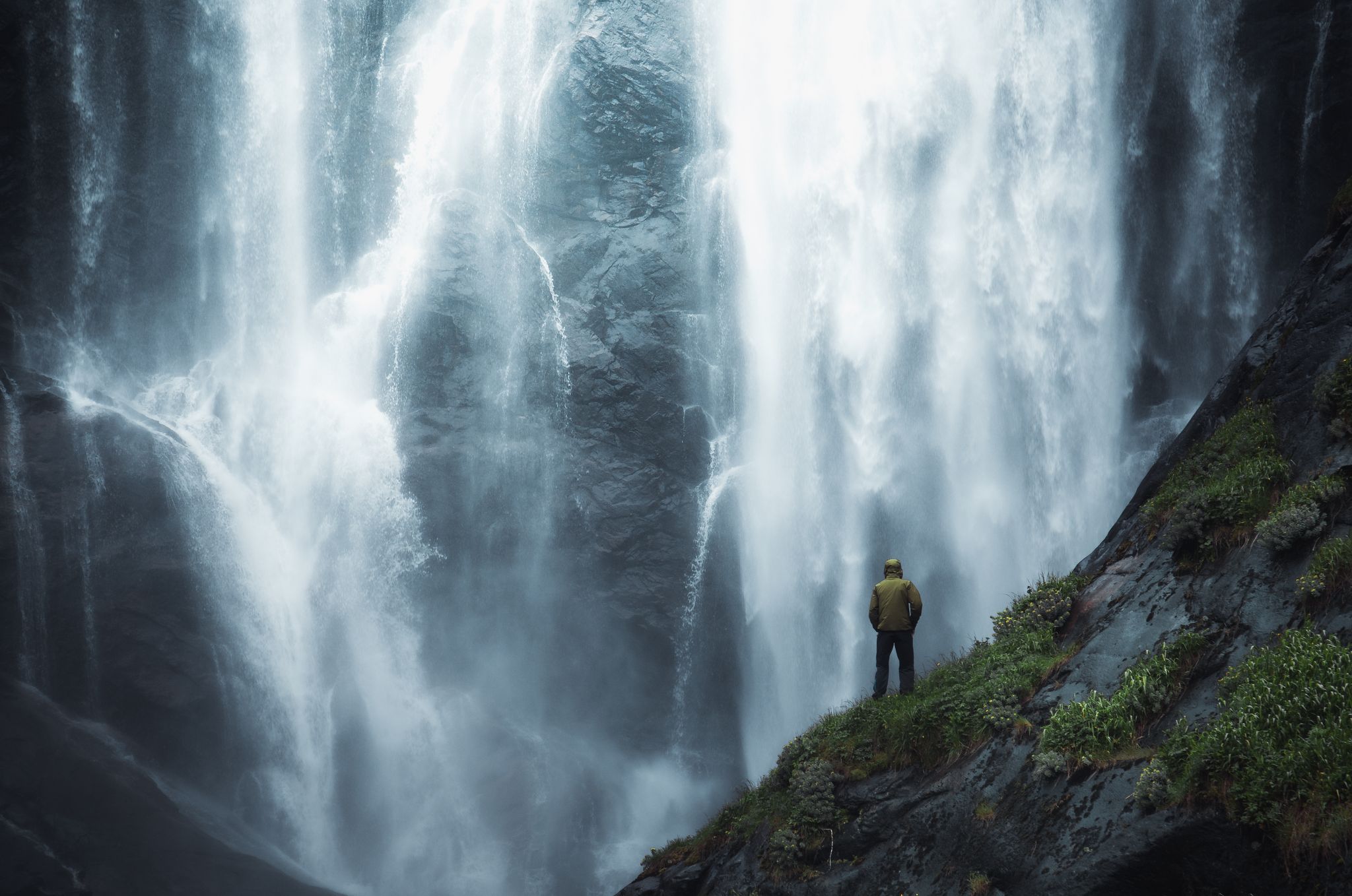 adventure man looking at waterfall in norway.