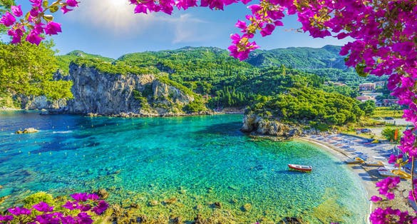 Photo of amazing beach with crystal clear water in Paleokastritsa, Corfu island, Greece.