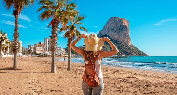 Photo of woman tourist on the tropical beach, Calpe, Alicante province in Spain.