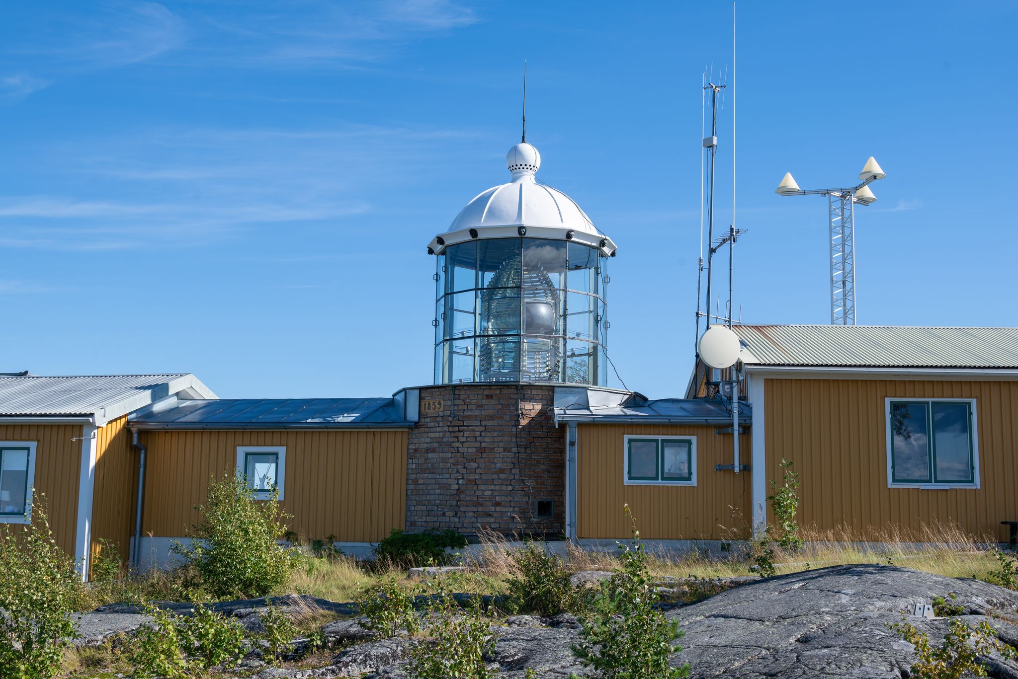 photo of view of Bjuroklubb lighthouse a national cultural heritage south of Skellefteå Sweden is an old lighthouse with a Fresnel lens which can be seen in the center of the image, the beacon is inactive.
