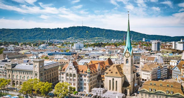 photo of aerial panoramic view of Zurich city center with famous Fraumunster Church and river Limmat at Lake Zurich from Grossmunster Church, Canton of Zurich, Switzerland.