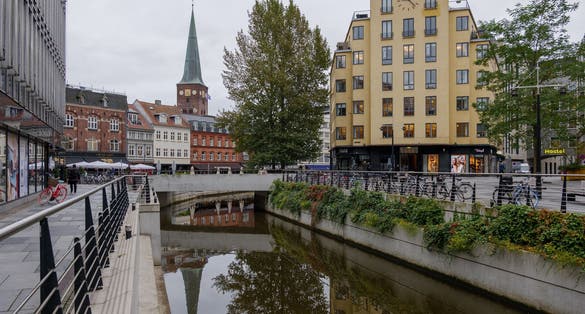 Outdoor exterior view of the old town and shopping walking district along canal in Aarhus, Denmark.