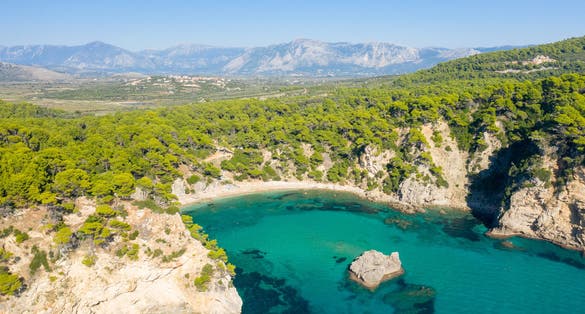 photo of Alonaki Fanariou sandy beach and its green rocky cliffs , in Europe, Greece, Epirus, towards Igoumenitsa, by the Ionian sea, in summer, on a sunny day.