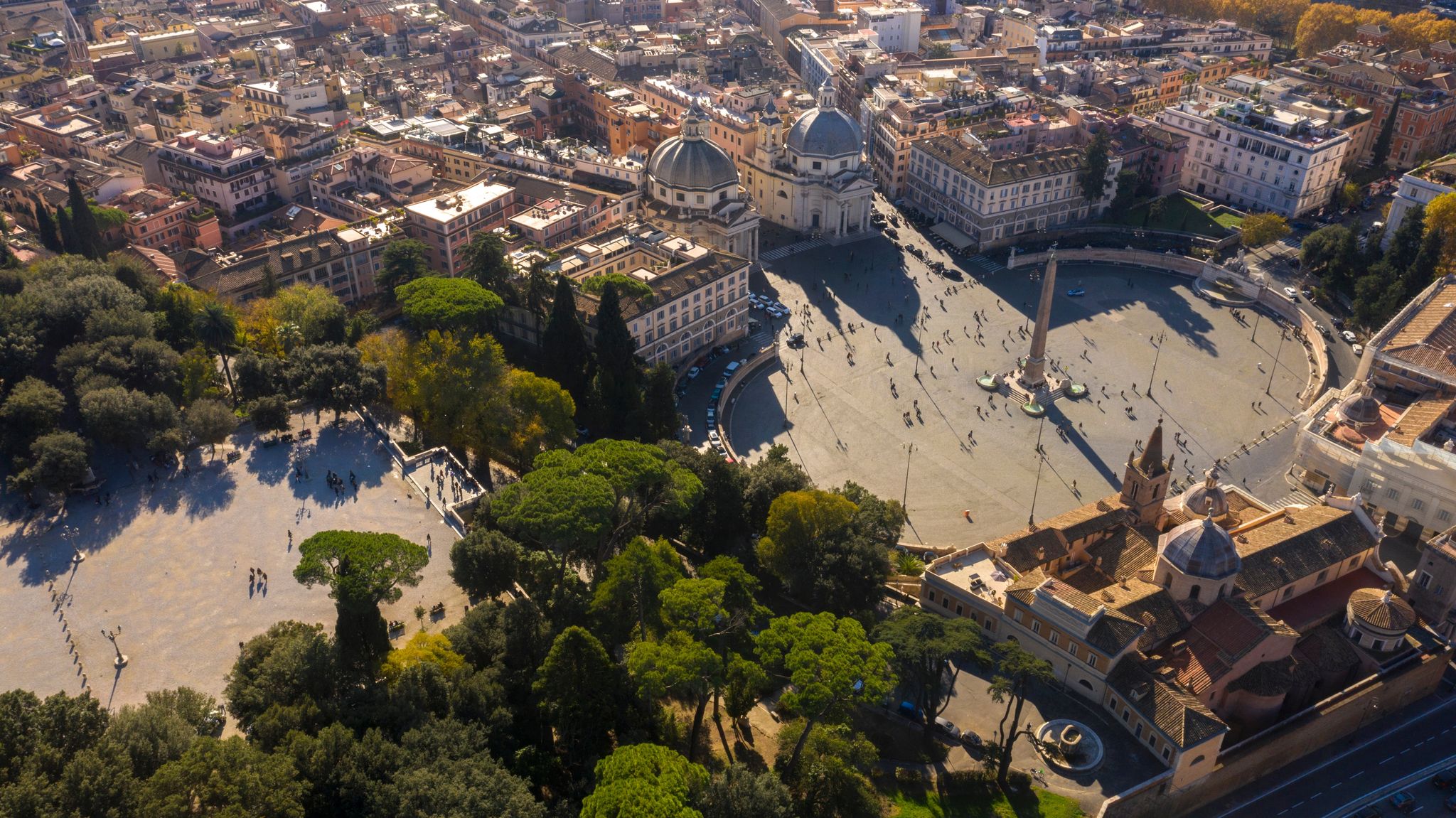 photo of aerial view of piazza del popolo, a large urban square, near the villa borghese gardens and the pincio terrace in Rome, Italy. In the square there is the flaminio obelisk known as popolo obelisk.