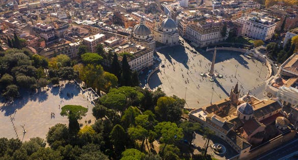 photo of aerial view of piazza del popolo, a large urban square, near the villa borghese gardens and the pincio terrace in Rome, Italy. In the square there is the flaminio obelisk known as popolo obelisk.
