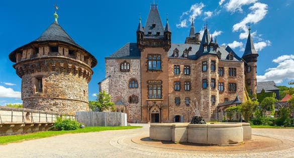 Wernigerode Castle with fountain and defensive tower in Wernigerode, Germany