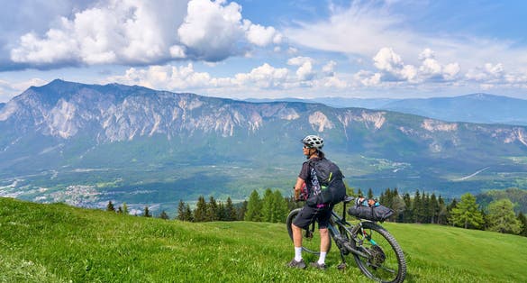 active senior woman on a mountain bike tour in the carinthian alps above Villach in Austria