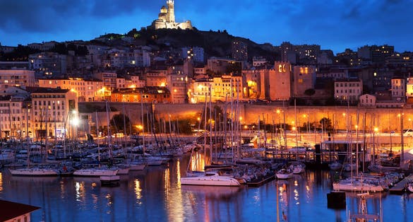 Marseille, France panorama at night. The famous european harbour view on the Notre Dame de la Garde