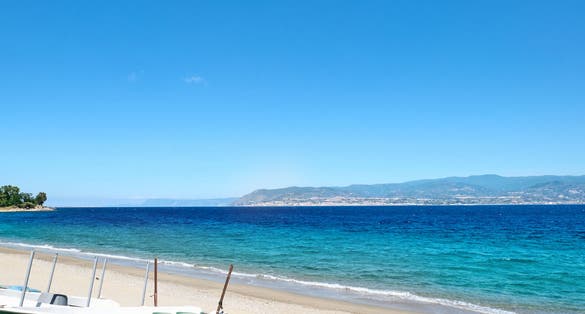 Sandy beach in Messina with views of Calabria and the Messina strait. Italy.