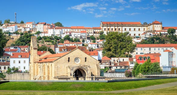 Monastery of Santa Clara a Velha in Coimbra, Portugal, on a sunny day and in the background the hill with its houses and at the top the Monastery of Santa Clara a Nova.