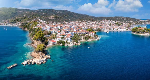 Photo of panoramic view to the harbor and town of Skiathos island.