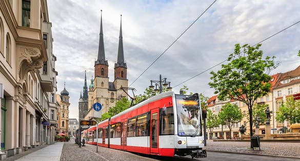 photo of view of Halle (Saale), Germany. Red tram going on Hallmarkt square in front of Marktkirche church in old town