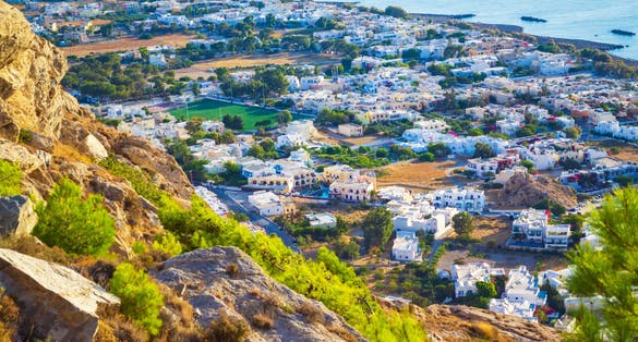 photo of view Scenic view of Kamari village and beach at sunrise seen from Mesa Vouno mountain,Scenic view of Kamari village and beach at sunrise seen from Mesa Vouno mountain, Kamari, Greece,