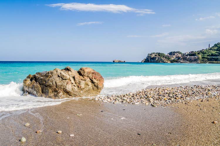 Photo of beautiful Spisone beach with clear blue sea, Taormina, Metropolitan City of Messina on east coast of island of Sicily, Italy.