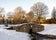 Photo of A small water stream coming under a scenic stone bridge in Westburn park, Aberdeen, Scotland .