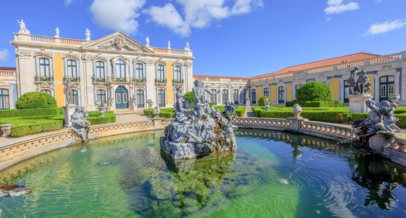 Photo of Baroque facade of Queluz National Palace and Neptune Fountain in Sintra, Lisbon district, Portugal.
