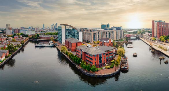 photo of view of Aerial drone view of Manchester city in UK on a beautiful sunny day.